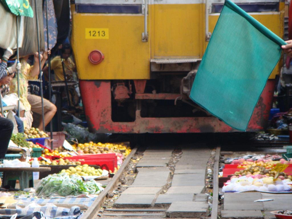 the canopy is pulled back and the market quickly moved so the train can pass