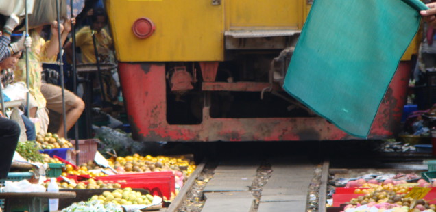 the canopy is pulled back and the market quickly moved so the train can pass